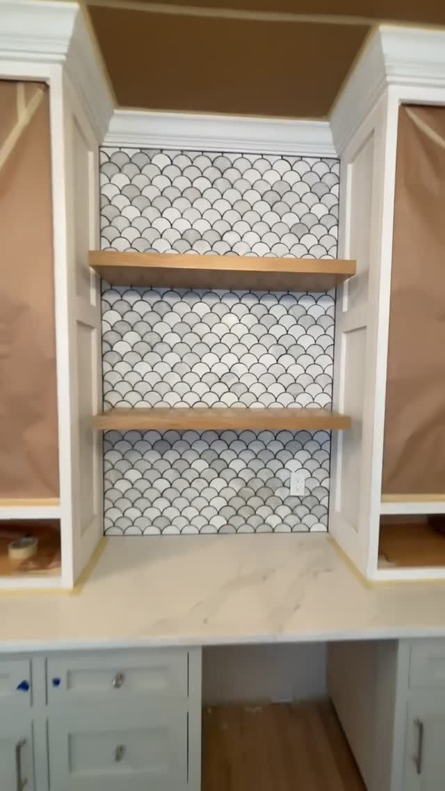 Fish-scale mosaic and floating shelves mid-installation by F.Z. Tile