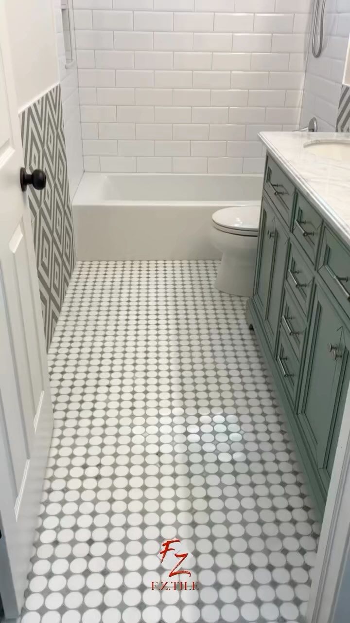 Bathroom with penny tile floor and green vanity