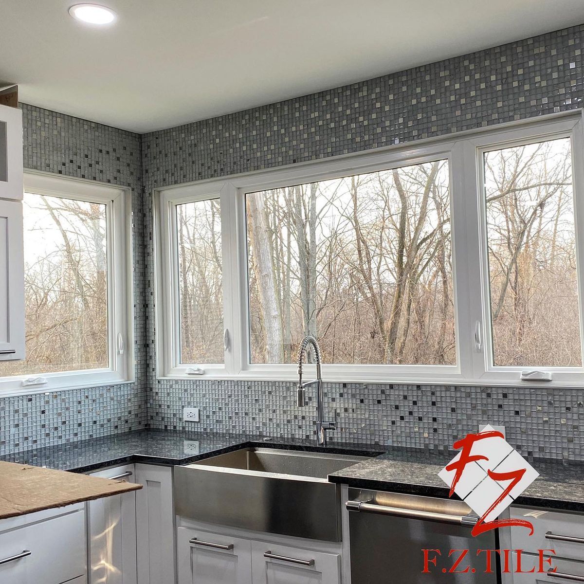 Kitchen mosaic backsplash with farmhouse sink and forest view, Lake County home