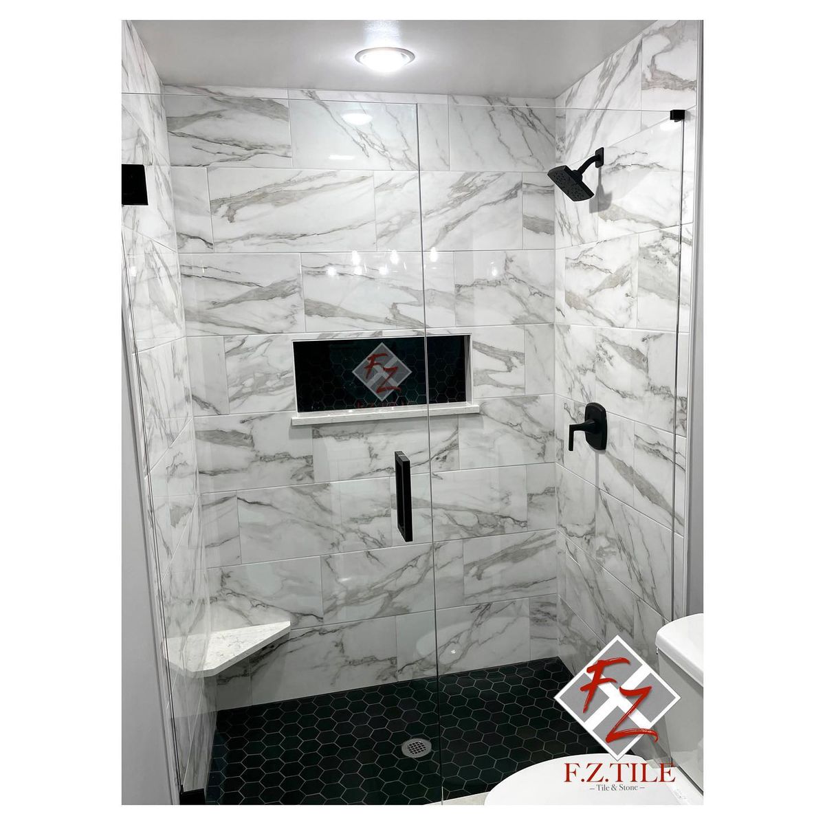 Calacatta marble shower with black hexagon floor